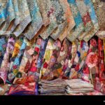 colorful-selection-of-termeh-traditional-persian-handwoven-cloth-embroidered-with-silk-displayed-in-a-handicraft-store-isfahan-iran-2X1JPCP